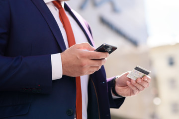 Man pays for a purchase with a credit card over the phone.