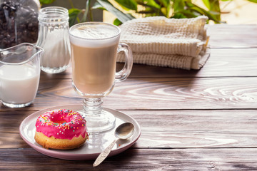 Cup of hot coffee latte beverages with donut glazed