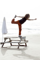 Plakat woman making yoga meditation at the beach