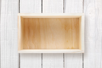 Wooden box on white wooden background