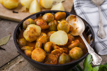Roasted fresh brussels sprouts in homemade ceramic bowl.
