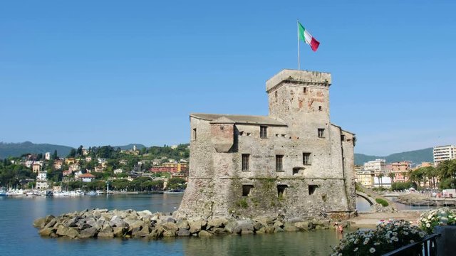 Rapallo - Genoa - Italy - The castle of Rapallo on the sea with a waving italian flag