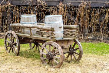 Fototapeta na wymiar Antique cart with three barrels for transporting goods