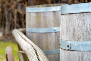 Naklejka premium Close-up of barrels for transporting goods on antique cart with three