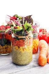 Homemade salad in glass jar with vegetables. Healthy food, diet, detox and clean eating