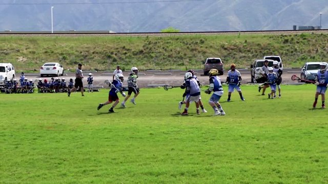 Boys 11-year-old youth lacrosse league play; good defense prevents a goal