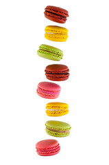Set of falling macarons cakes of different colors, isolated on a white background