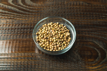 seasoning in a glass jar on a wooden background