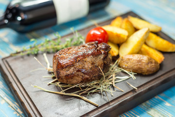 steak with potatoes on a wooden board