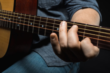 Fototapeta premium male hands play acoustic guitar