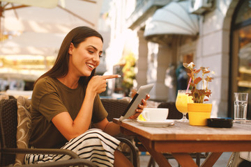 Young woman using a digital tablet in a cafe