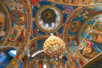 Fototapeta na wymiar Orthodox church ceiling with fresco and chadelier