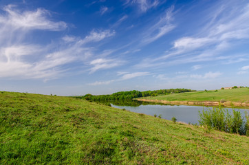 Fototapeta na wymiar Blue sky over the river in the steppe.