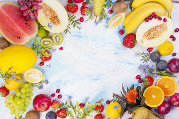 Different fruits on a light background. Vitamins and diet. Summer berries and fruits. Healthy food. Background and space for text. Vegetarian