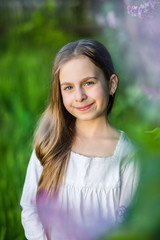 Portrait of cute girl in the spring garden