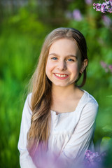 Portrait of cute girl in the spring garden