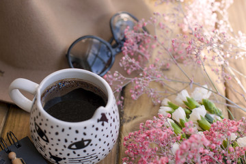 Black fragrant coffee, flowers, hat and glasses. Good morning . Women's accessories.