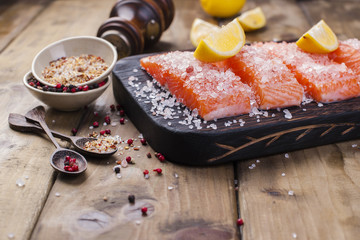 Salmon steaks with large salt, lemon and spices. Preparation of tasty and healthy food. Place for text. Seafood