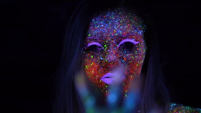 Portrait of Beautiful Fashion Woman in Neon UV Light. Model Girl with Fluorescent Creative Psychedelic MakeUp, Art Design of Female Disco Dancer Model in UV