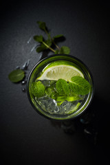 Lemonade or citrus cocktail with ice and mint overhead shot