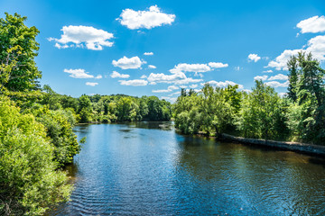 Landscape, blue-sky with light summer clouds, over a river.
