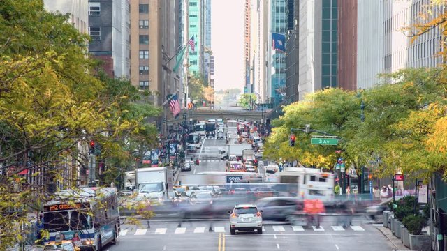 Time Lapse video of a long line of cars, taxi, buses and people on the 42nd street of Manhattan, New York City, USA.