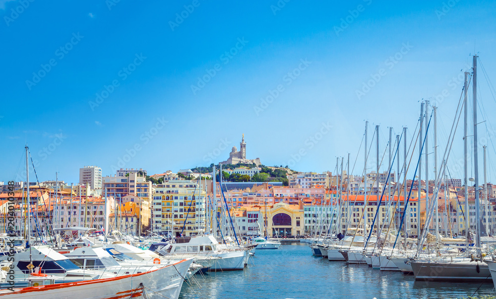 Wall mural summer view on basilica of notre dame de la garde and old port in marseille, france