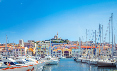 Summer view on basilica of Notre Dame de la Garde and old port in Marseille, France - obrazy, fototapety, plakaty