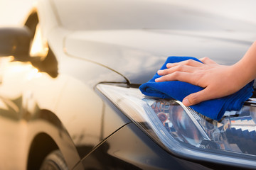 Close-Up of Woman Hand is Cleaning Her Car With Cleaner Microfiber Cloth, Car Washing and Vehicle...