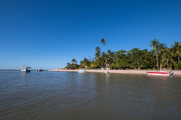 Tropical island with fishing boat in the sea