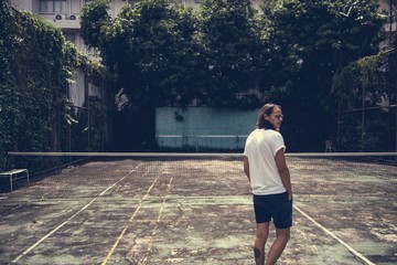Man standing in a tennis court