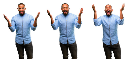 African american man with beard happy and surprised cheering expressing wow gesture