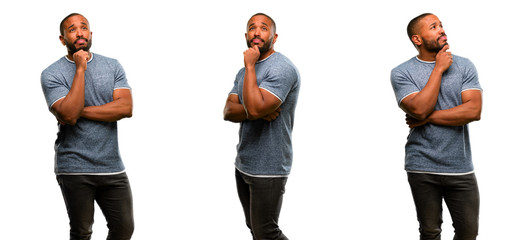 Obraz premium African american man with beard thinking and looking up expressing doubt and wonder