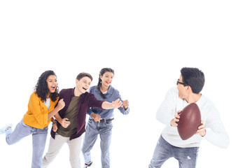 interracial teen friends playing with rugby ball isolated on white