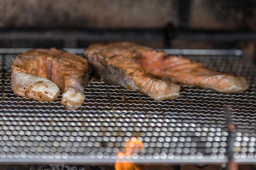 Fresh salmon barbecue cut into baked charcoal pieces