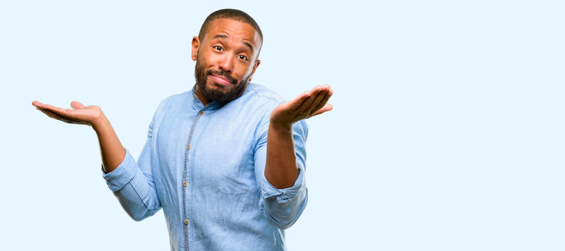 African american man with beard doubt expression, confuse and wonder concept, uncertain future isolated over blue background