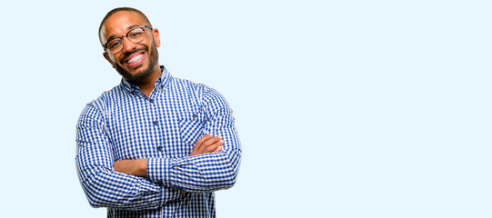 African american man with beard with crossed arms confident and happy with a big natural smile laughing isolated over blue background