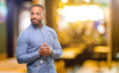 African american man with beard confident and happy with a big natural smile laughing at night