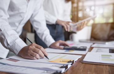 Businessmen holding pencil and  working with business graph report