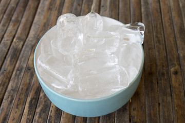 ice cubes in the bowl on bamboo table