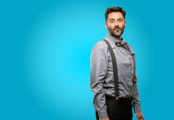 Obraz premium Middle age man, with beard and bow tie confident and happy with a big natural smile looking at camera