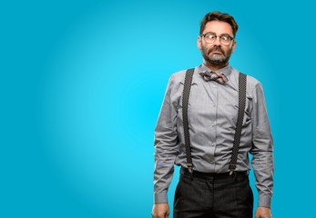 Obraz premium Middle age man, with beard and bow tie making funny face fooling