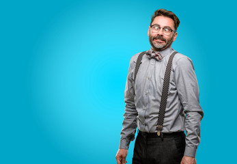 Obraz premium Middle age man, with beard and bow tie making funny face fooling