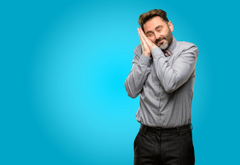 Middle age man, with beard and bow tie tired and bored, tired because of a long day overworking