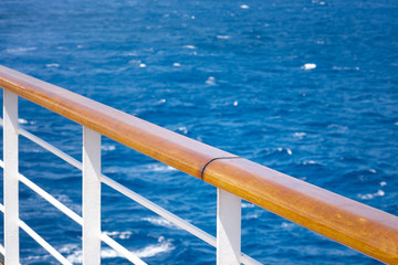 Naklejka premium Cruising, relaxation at sea and maritime travel by cruise ship concept with a peaceful scene of a handrail with nobody around it, overlooking the tranquil ocean on a warm summer day with copy space