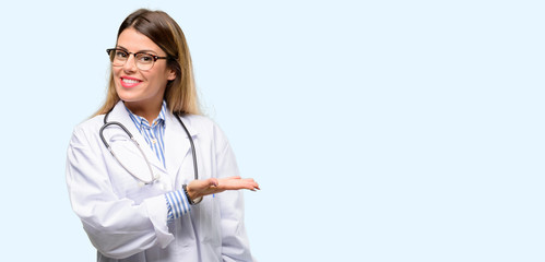 Young doctor woman, medical professional holding something in empty hand