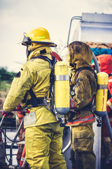 Fototapeta premium Firemen in firefighter uniform preparing equipment and tool.