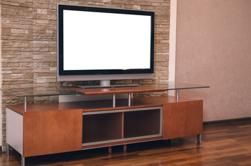 Modern TV set with empty blank screen on the table on the decorative brick wall background.