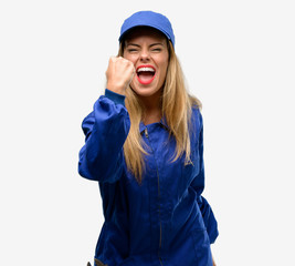 Young plumber woman irritated and angry expressing negative emotion, annoyed with someone