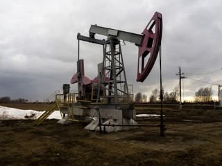 The beam pumping unit is homework, sunset in oil field